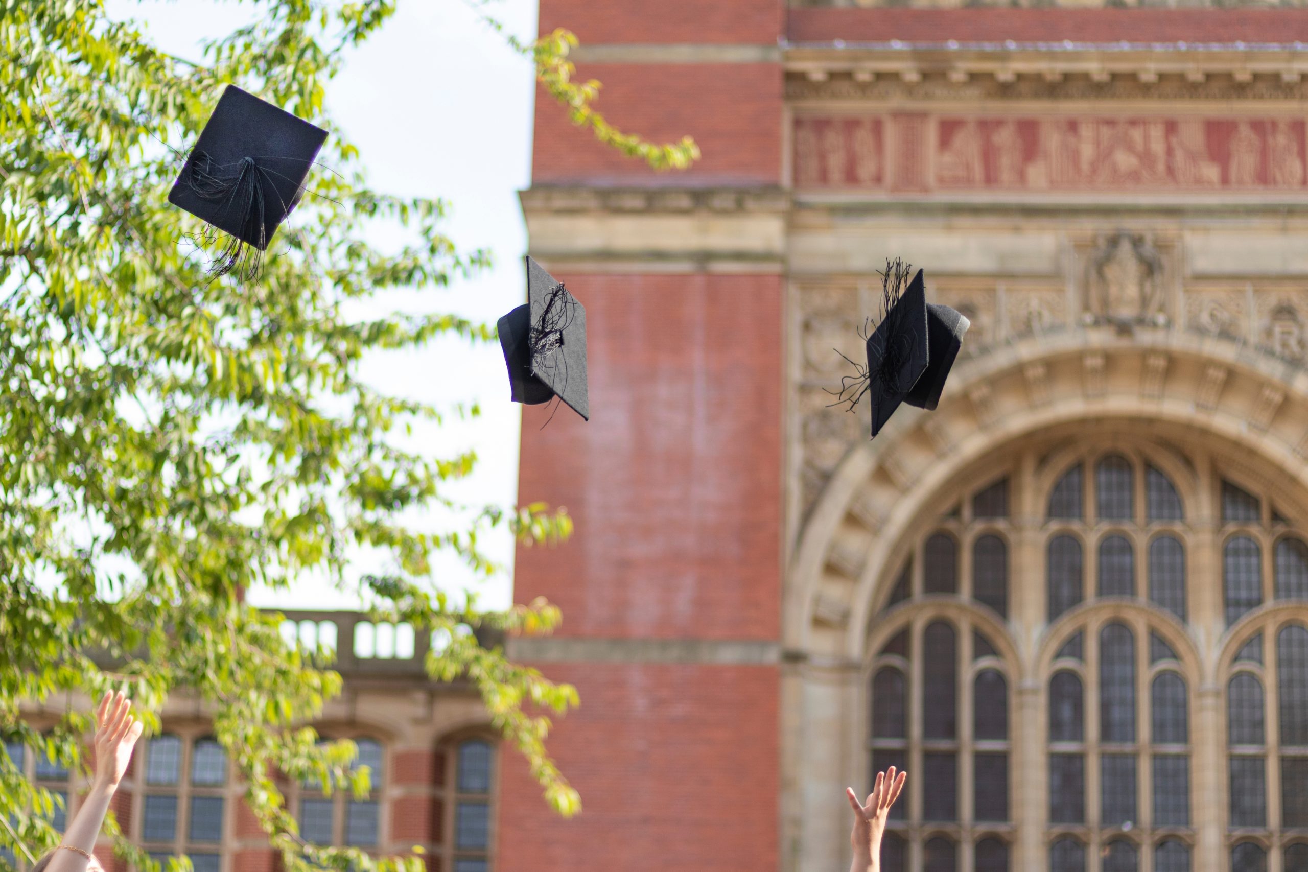 Graduates throwing hats in the air Graduates throwing hats in the air